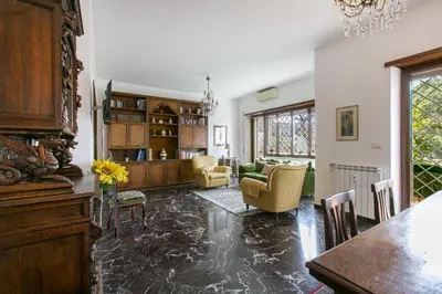 a kitchen and living room with a table and chairs at Rosso Levanto House in Rome