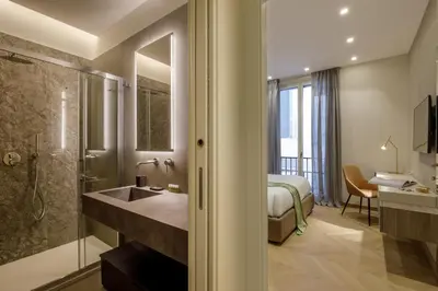 a bathroom with a sink and a shower and a bed at Daplace - Felicia Apartment in Rome