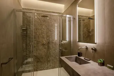 a bathroom with a glass shower with a sink at Daplace - Felicia Apartment in Rome