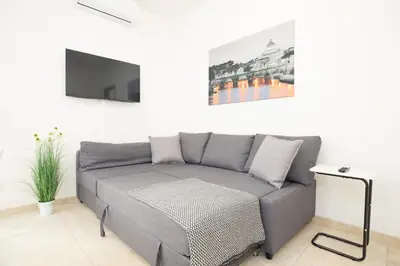 a living room with a couch and a tv at Casa Luna in Rome