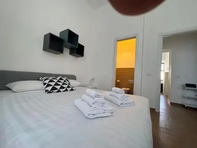 a bedroom with a white bed with towels on it at Vaticano Apartment in Rome