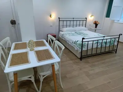 a bedroom with a bed and a table and chairs at Sweet Rome Holiday Flaminio-The biggest shower in Rome
