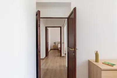 an open door leading into a room with a hallway at iFlat Bright Brand New 3-Bedroom Apt in Monti in Rome