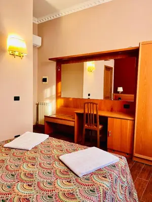 a bedroom with a bed and two lamps on the wall at Beauty Rooms in Rome