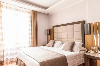 a bedroom with a large bed and a window at Vibe Nazionale in Rome