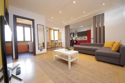 a living room with a couch and a table at Cozy and comfy apartment in Piramide metro stop in Rome