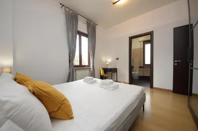 a bedroom with a large white bed with yellow pillows at Cozy and comfy apartment in Piramide metro stop in Rome