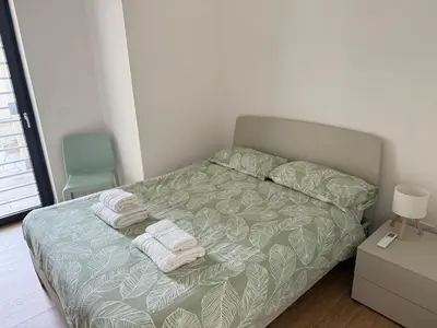 a bedroom with a bed with towels on it at Voluptas House Termini San Lorenzo in Rome