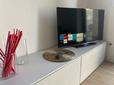 a tv sitting on top of a cabinet with a remote control at Voluptas House Termini San Lorenzo in Rome