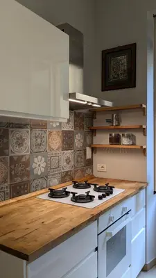 a kitchen with a counter top with a stove top oven at Appartamento C9 in Rome