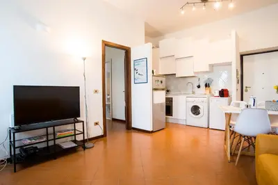 a table with cups and flowers on it at Casa Geco Cozy apartment near St Peter in Rome