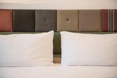 a lamp on a night stand next to a bed at Casa Geco Cozy apartment near St Peter in Rome