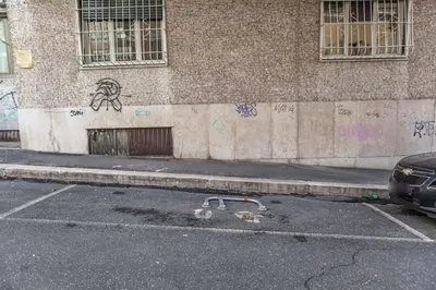 a building with graffiti on the side of a street at Domus 124, elegant city Comfort with Parking in Rome
