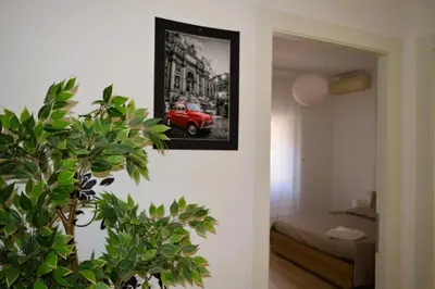 a room with a picture of a red car on the wall at Fem House in Rome