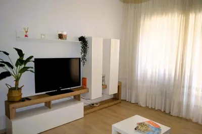 a living room with a flat screen tv on a white wall at Fem House in Rome