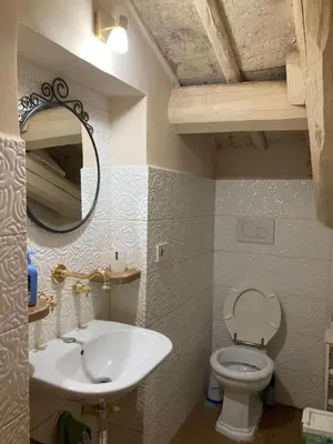 a bathroom with a sink and a toilet and a mirror at G&A Rome House in Rome
