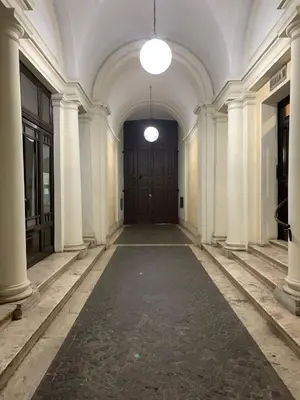 an empty hallway with a large door in a building at G&A Rome House in Rome