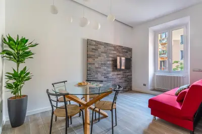 a living room with a table and a red couch at iFlat Radiant retreat in Esquilino in Rome