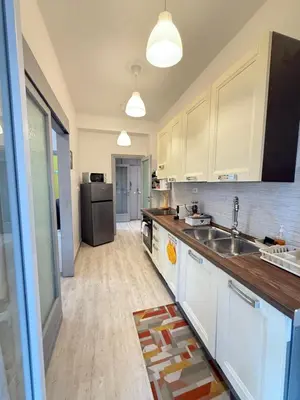 a kitchen with a sink and a refrigerator at La Casa di Aimara in Rome
