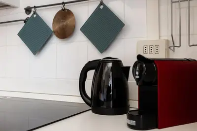a black coffee pot sitting on a counter next to a toaster at Montagnola Mini House in Rome