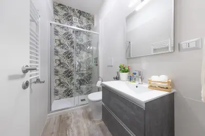 a bathroom with a toilet and a sink and a shower at Amora Apartments in Rome