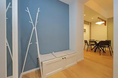 a room with a bench and a dining room with a table at Modern Family Apartment in Rome