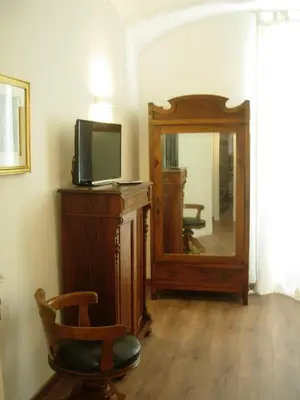 a room with a mirror and a tv and a chair at Epic Home in Rome