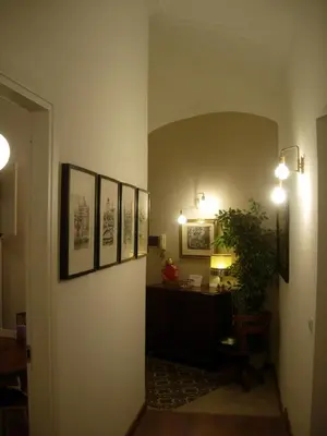 a hallway with a desk and pictures on the wall at Epic Home in Rome