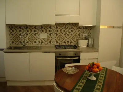 a kitchen with a table with a bowl of fruit on it at Epic Home in Rome