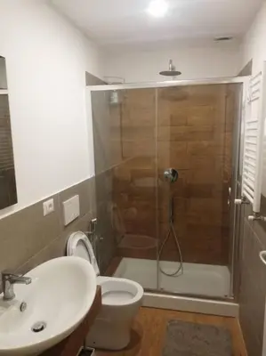 a bathroom with a shower and a toilet and a sink at Epic Home in Rome
