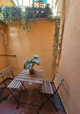 a wooden table and a potted plant on a patio at Roma Sweet Dreams casa vacanze in Rome