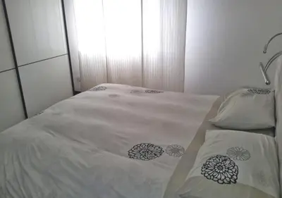 a white bed with flowers on it in a bedroom at La casa Bomboniera in Rome