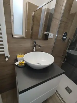 a bathroom with a white sink and a shower at WelcRome Appartamento Roma Centro in Rome