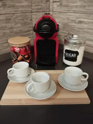 two cups and saucers on a cutting board with a coffee maker at WelcRome Appartamento Roma Centro in Rome