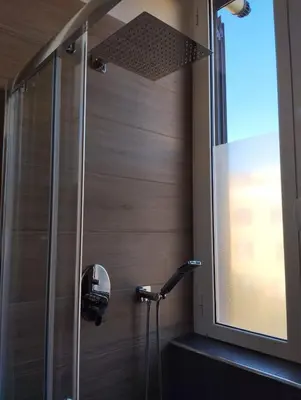 a shower in a bathroom with a window at WelcRome Appartamento Roma Centro in Rome