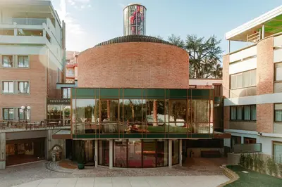 an external view of a brick building with glass at Adoro Hotel in Rome
