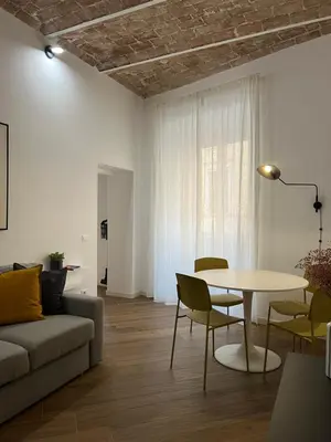 a living room with a table and a couch at Civico26 in Rome