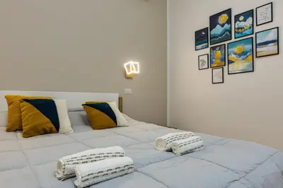 a large white bed with two pillows on it at Casa di Azzurra in Rome