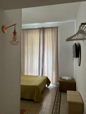 a bedroom with a bed and a window with curtains at Don sweet home- Hedi 101 in Rome