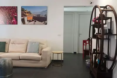 a living room with a white couch and a staircase at Un angolo di Oriente a due passi da San Pietro in Rome