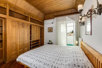 a bedroom with a bed and a wooden ceiling at Elegante appartamento 130mq in stile classico in Rome