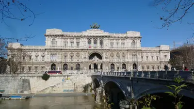 a large building with a bridge over a river at Terrace & 1930s Charm - Vatican Walk in Rome