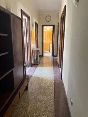 a hallway with a clock on the wall and a clock on the wall at Terrace & 1930s Charm - Vatican Walk in Rome