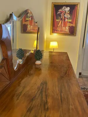 a living room with a wooden table and a lamp at Terrace & 1930s Charm - Vatican Walk in Rome