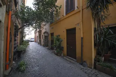 an alley with buildings and plants on a street at Domus Minelli Navona by GHOR in Rome