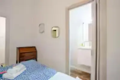 a bedroom with a blue bed and a mirror at Charme Holidays Trastevere in Rome