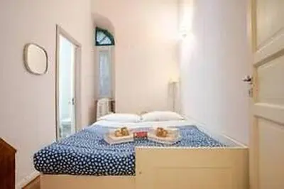 a bedroom with a bed with two plates on it at Charme Holidays Trastevere in Rome