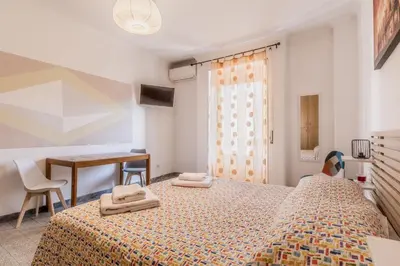 a bedroom with a bed with two towels on it at Galaxia Home in Rome