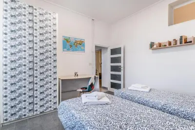 a white room with two beds and a mirror at Galaxia Home in Rome