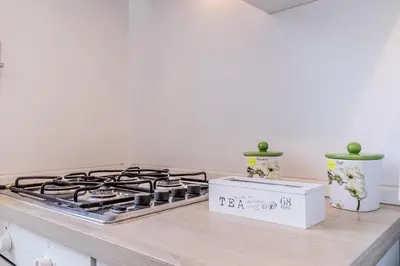 a kitchen counter with a stove and a box at Galaxia Home in Rome